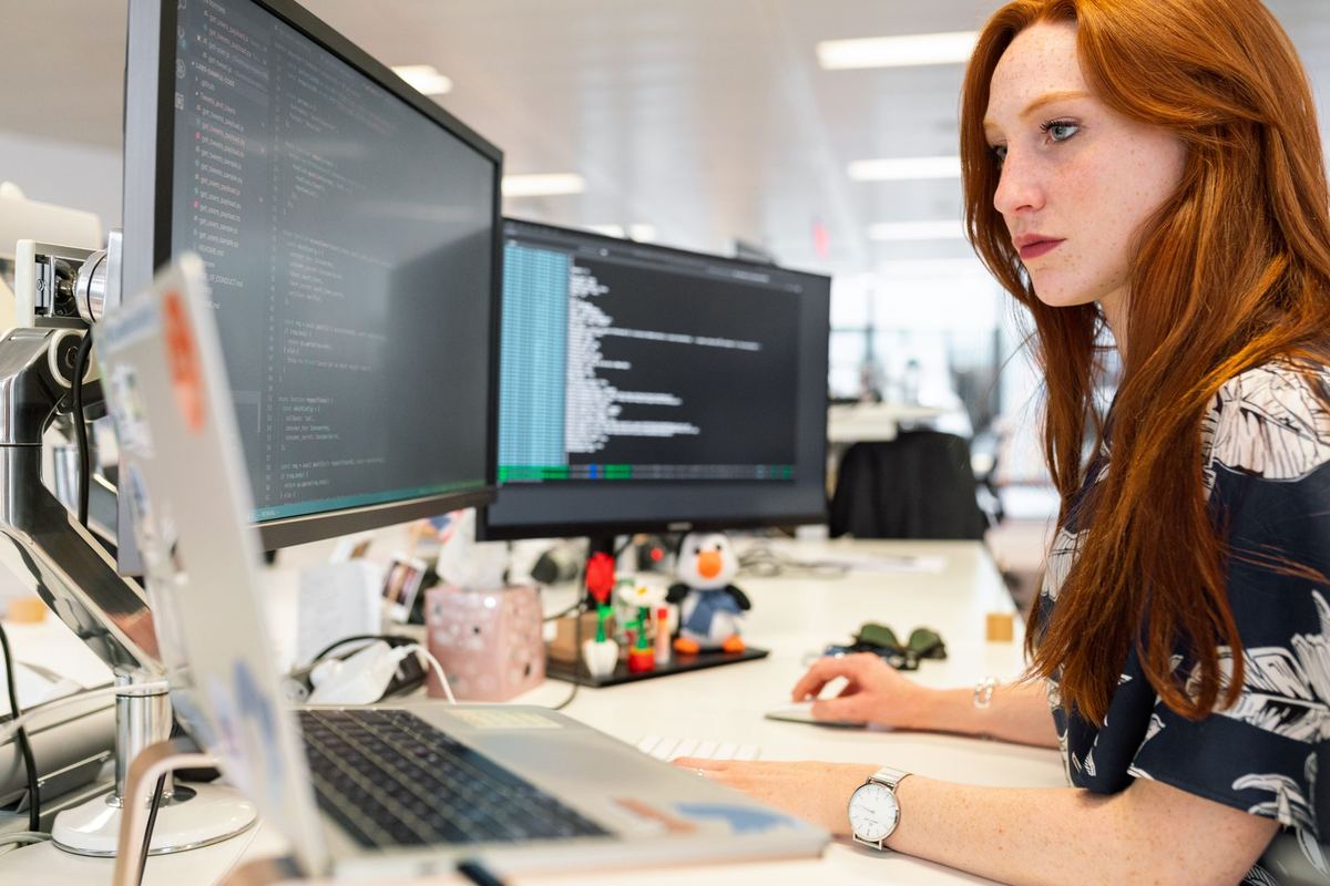 An engineer at two monitors
